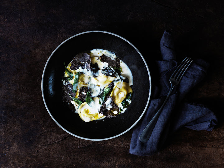 Spinach and ricotta Ravioli with parmesan sauce and truffles